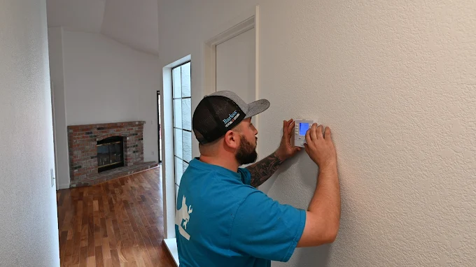 Barker technician installing a smart thermostat