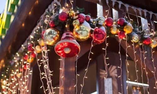 Festive Christmas decorations with red and gold ornaments and string lights for seasonal HVAC-themed celebration.